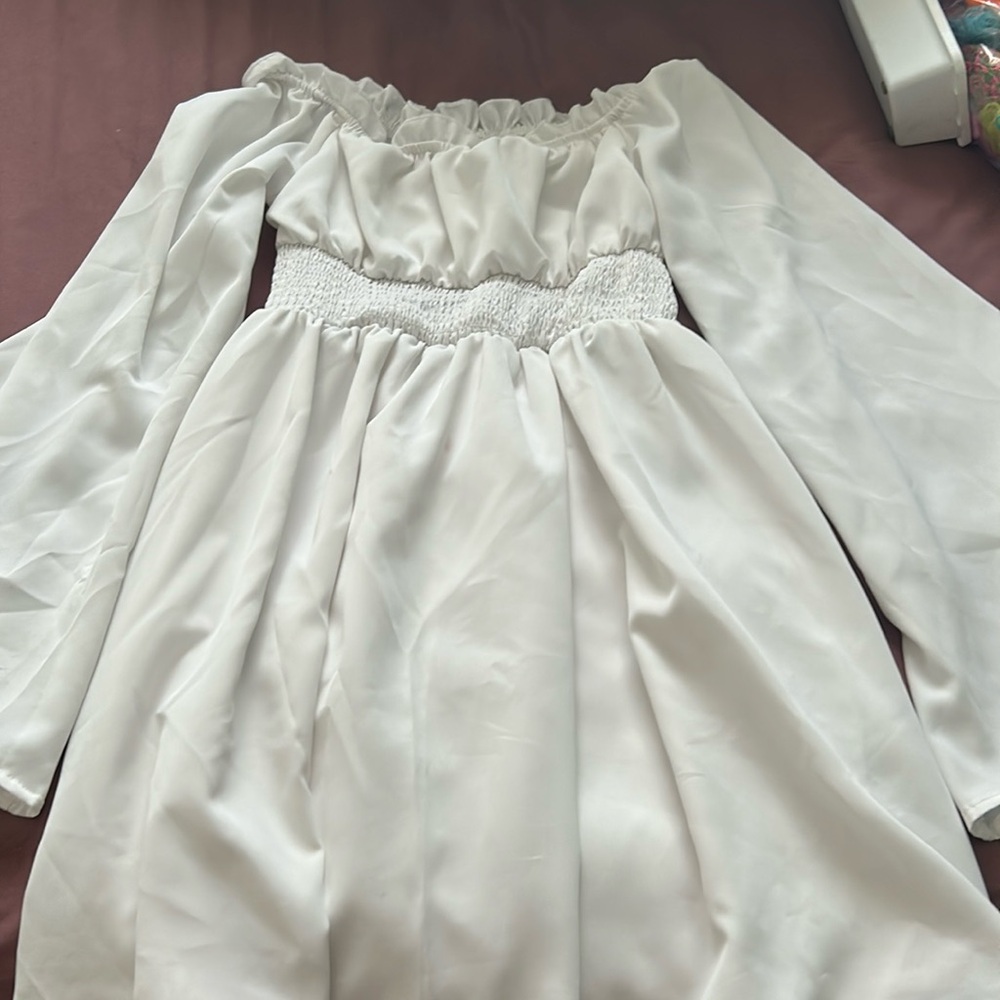 a white off the shoulder dress